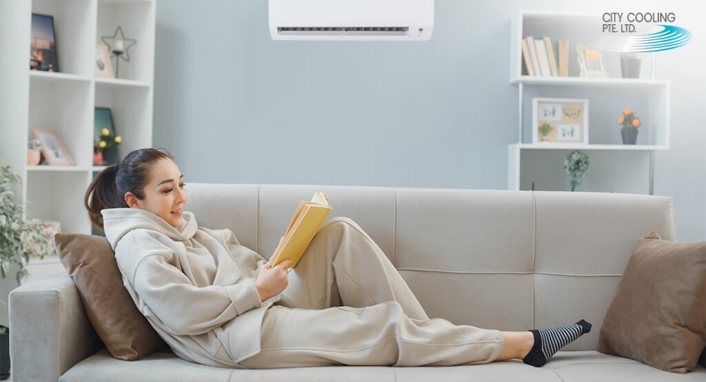 A Girl sitting on a sofa enjoying aircon-Aircon service